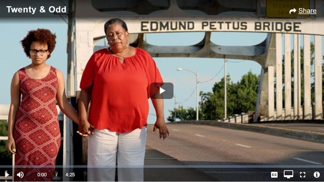 in a thumbnail video image, two women stand in front of the Edmund Pettus Bridge