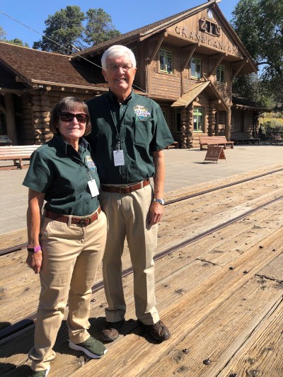 Man and woman standing in front of Grand Canyon rail station