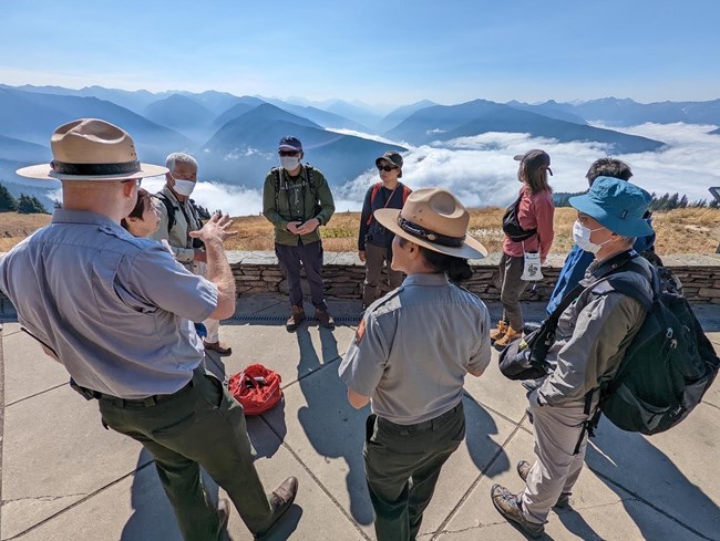 A ranger at Olympic National Park talks to a Japanese delegation.