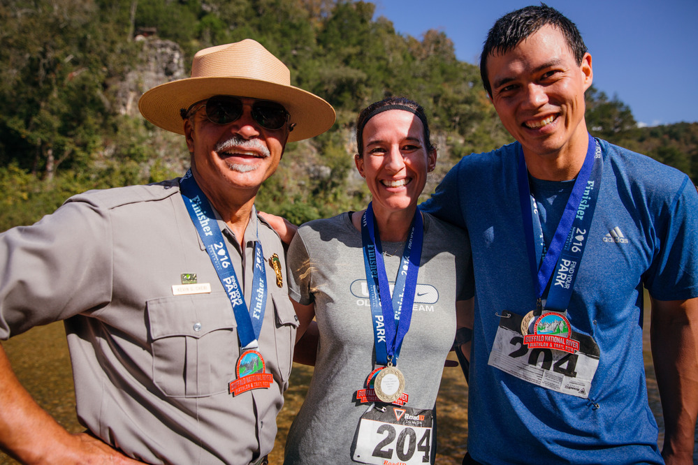 Superintendent Kevin Cheri, in uniform, posing for an photo with two first place finishers of a biathlon