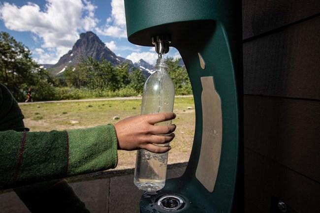 a water bottle is filled at a water bottle filling station