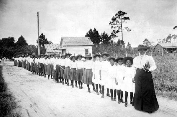 Mary McLeod Bethune with girls from the Literary and Industrial Training School for Negro Girls in Daytona, c. 1905. Public Domain.