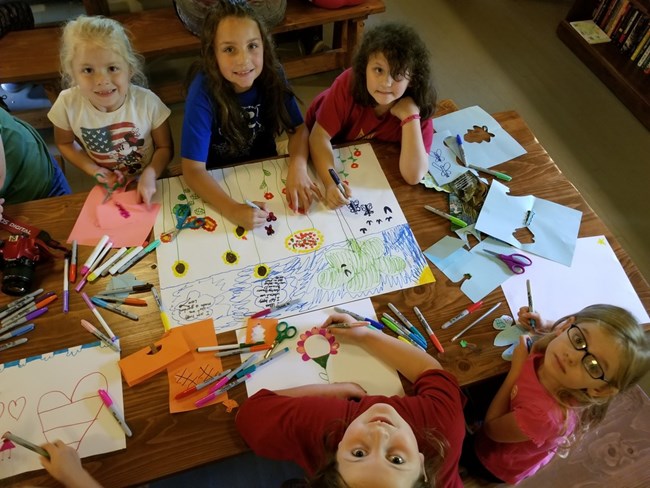 Girl Scouts creating artwork.