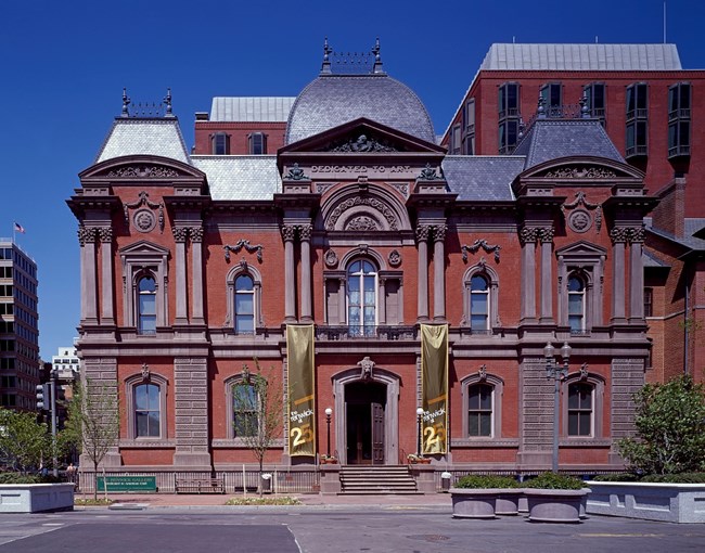 Contemporary photograph of the Renwick Gallery designed in Second Empire style with mansard roof and ornamental massing.