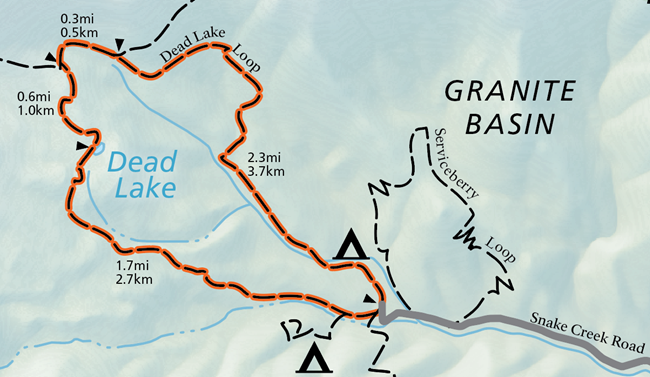 A color image of the official national park map. A grey line labeled "Snake Creek Road" emerges from the right, and an orange highlighted trail labeled "Dead Lake Loop" extends from its end.