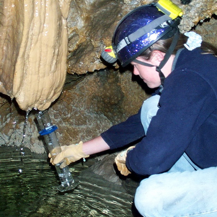 Cami Pulham taking a water quality sample from Hansen Cave