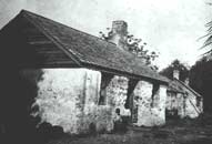 Children in front of one of the slave cabins