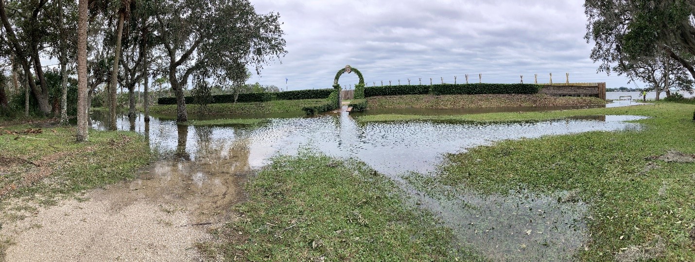 Water pools in front of a fort exhibit.