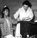 Girl being finger printed at Tule Lake Segregation Camp