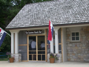 Small stone brick building with screen doors entering the front of the Valley Forge Canteen.