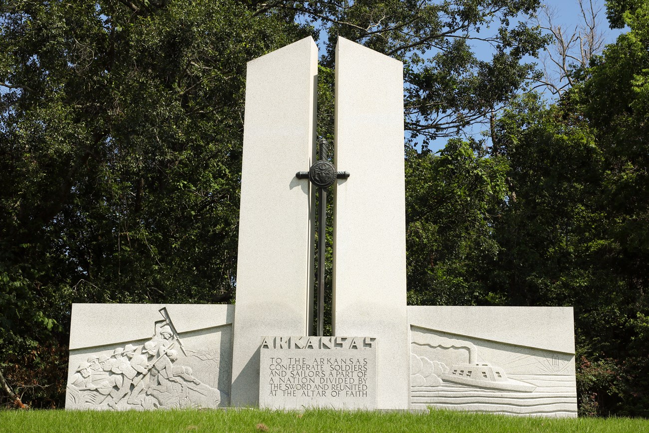 A large concrete memorial that reads "To the Arkansas Confederate Soldiers and Sailors, a part of a nation divided by the sword and reunited at the altar of faith."