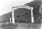 Arch over dirt road. Arch says,