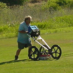 2005-2006 Geophysical Investigations
In 2005 and 2006, archeologists conducted research around the Grist Mill, Great Grave, Mission House, and First House. The archeologists used three non-invasive, geophysical survey techniques: magnetic survey, conductivity survey, and a ground penetrating radar survey. To “ground truth” the data being received, two small test pits were dug.  The test pits and geophysical survey data support the accuracy of the current building outlines and the presumed location of the Grist Mill. The data also suggest that there are buried structures in and near the Pioneer Cemetery that were previously unknown. This information will help park managers protect the park’s buried cultural resources when park improvements are planned in the future. Photos.