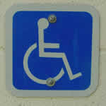 Accessibility logo: stylized person in a wheelchair.