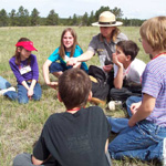 Ranger and a group of school children working together during an environmental education program
