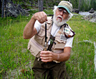 A man examines a fish.