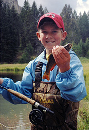 Junior fisherman proudly displays his catch.
