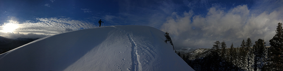 Christmas Day dawn patrol, skier on top of Lembert Dome