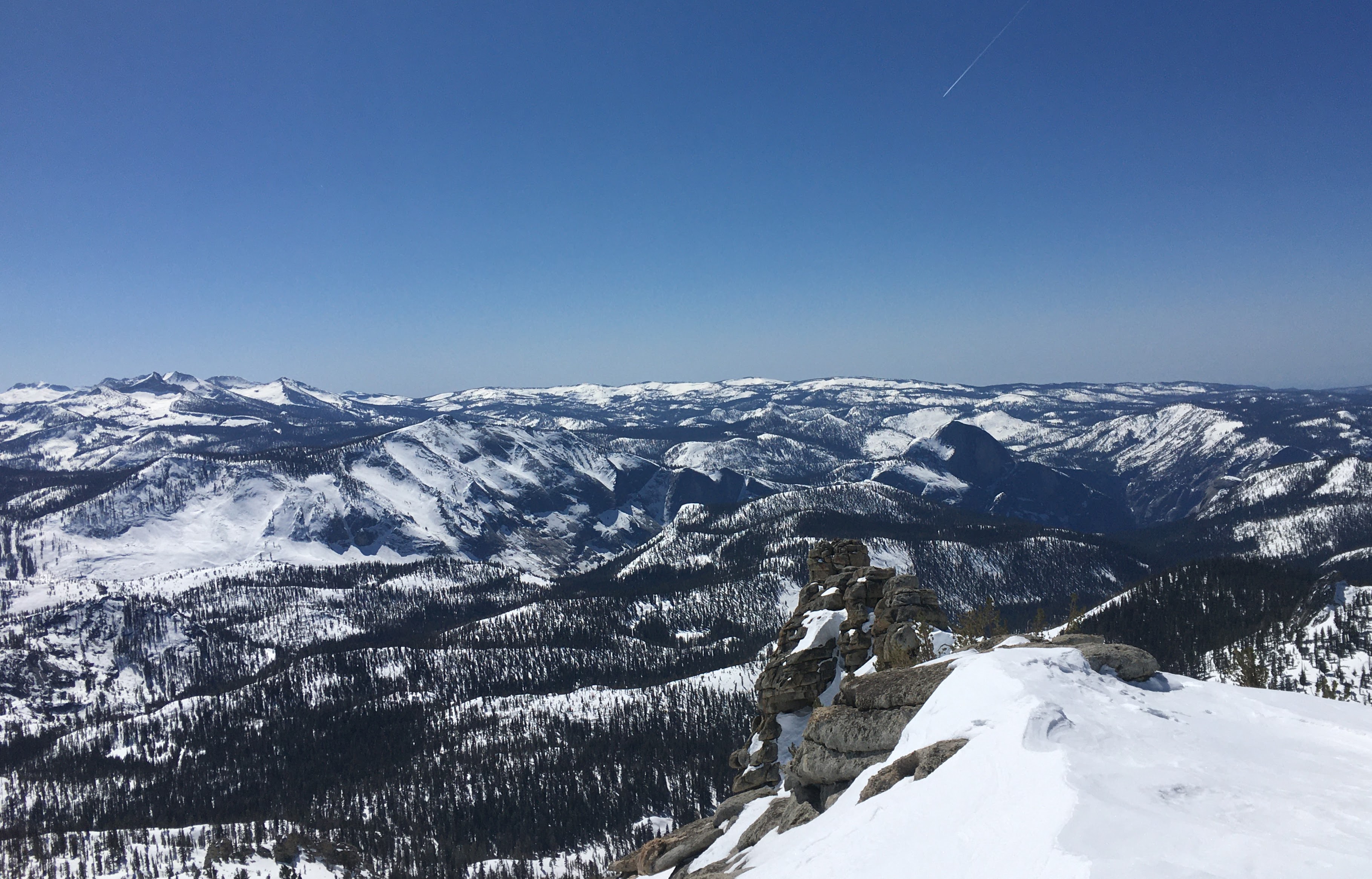 View from high peak to the south of Yosemite; forested snowy landscape off into the distance