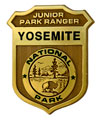 gold ranger badge that says Yosemite