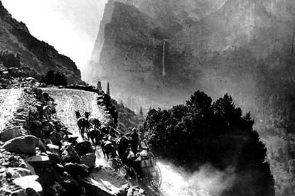 Carriage moves fast on dirt road on edge of tall slope