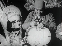 An American Indian woman makes baskets