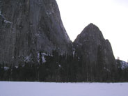 Lower and Middle Cathedral Rock loom over snow covered meadow
