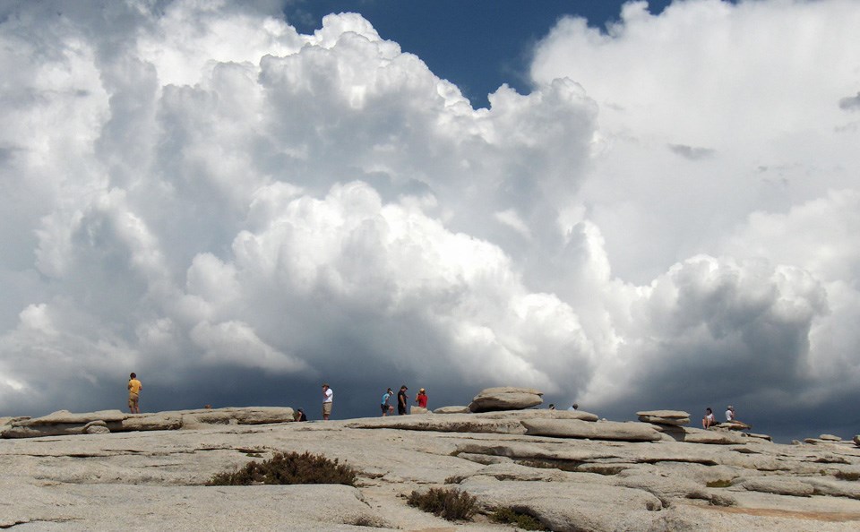 Towering cumulus clouds as seen from the top of Half Dome.