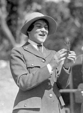 Pauline Mead Patraw in uniform, holding a blade of grass, smiling