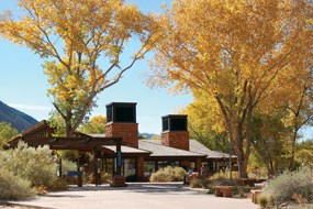 Zion Canyon Visitor Center with yellow cottonwood trees in the fall.