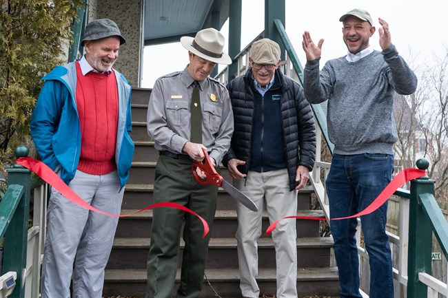 Ribbon cutting event featuring park superintendent and park partners.