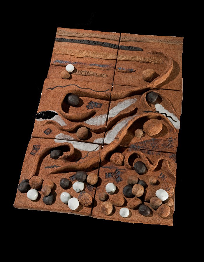 Abstract sculpture made of clay representing waves and rocks.