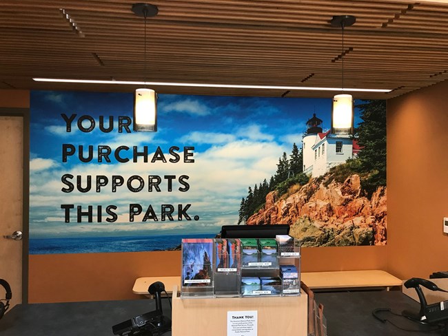 a sign behind a retail desk that says 'this store supports this park'