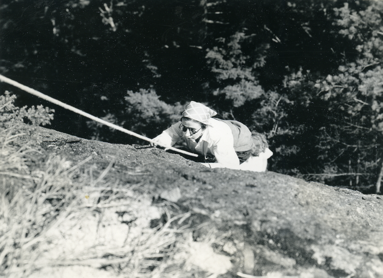 Historic photograph of a woman rock climbing
