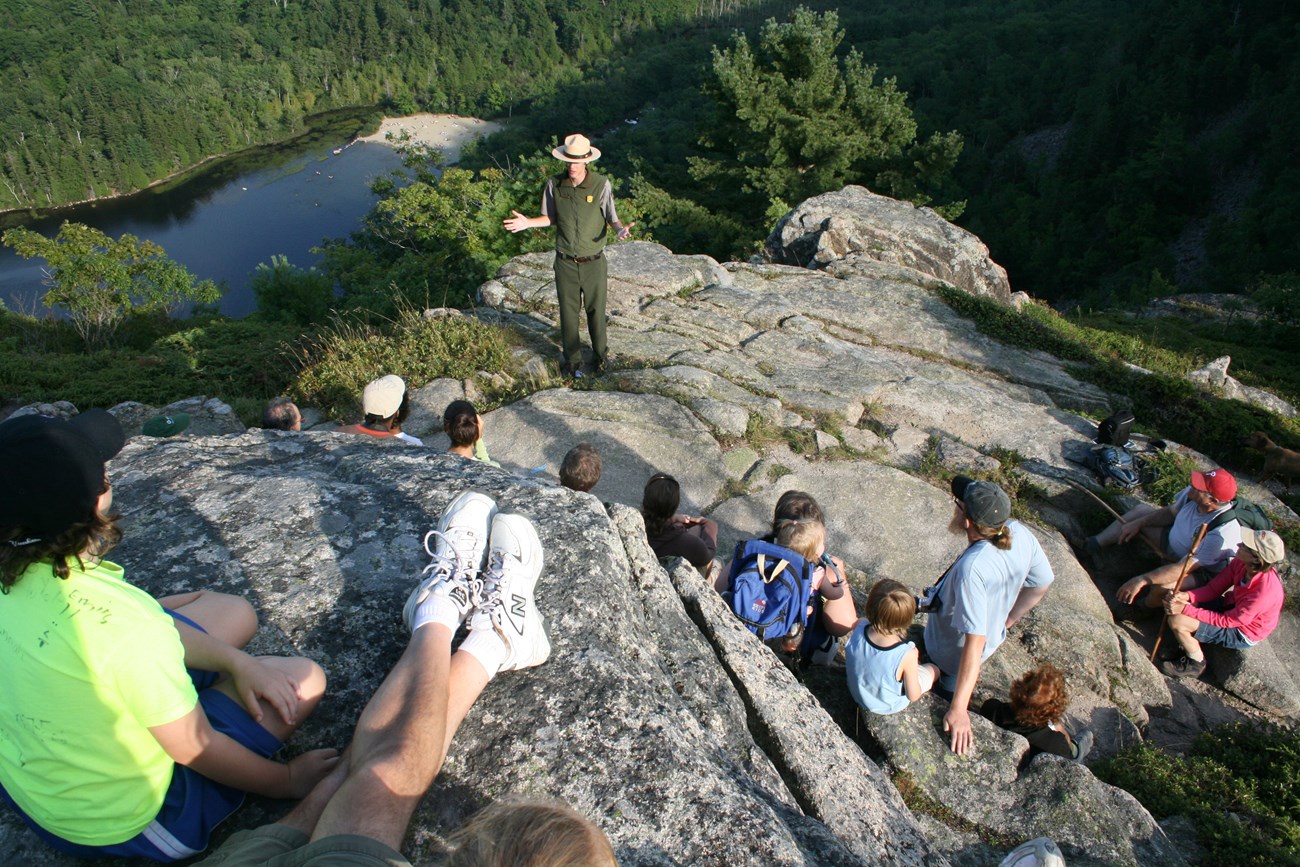 a ranger talks to a group high up on a mountain