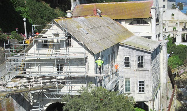men on scaffolding around building