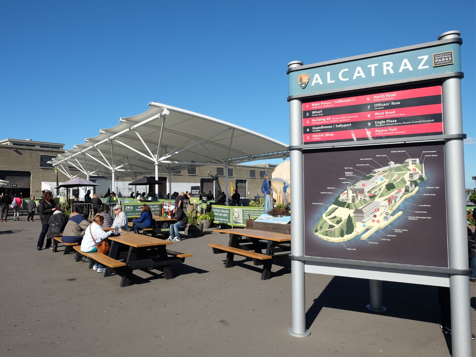 A sign giving directions with a map of Alcatraz on the dock.