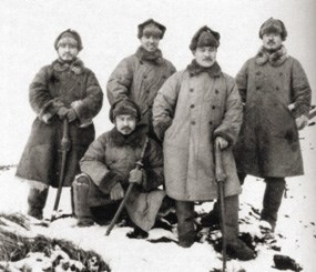 Historic photo of five Japanese men posing in winter coats and hats