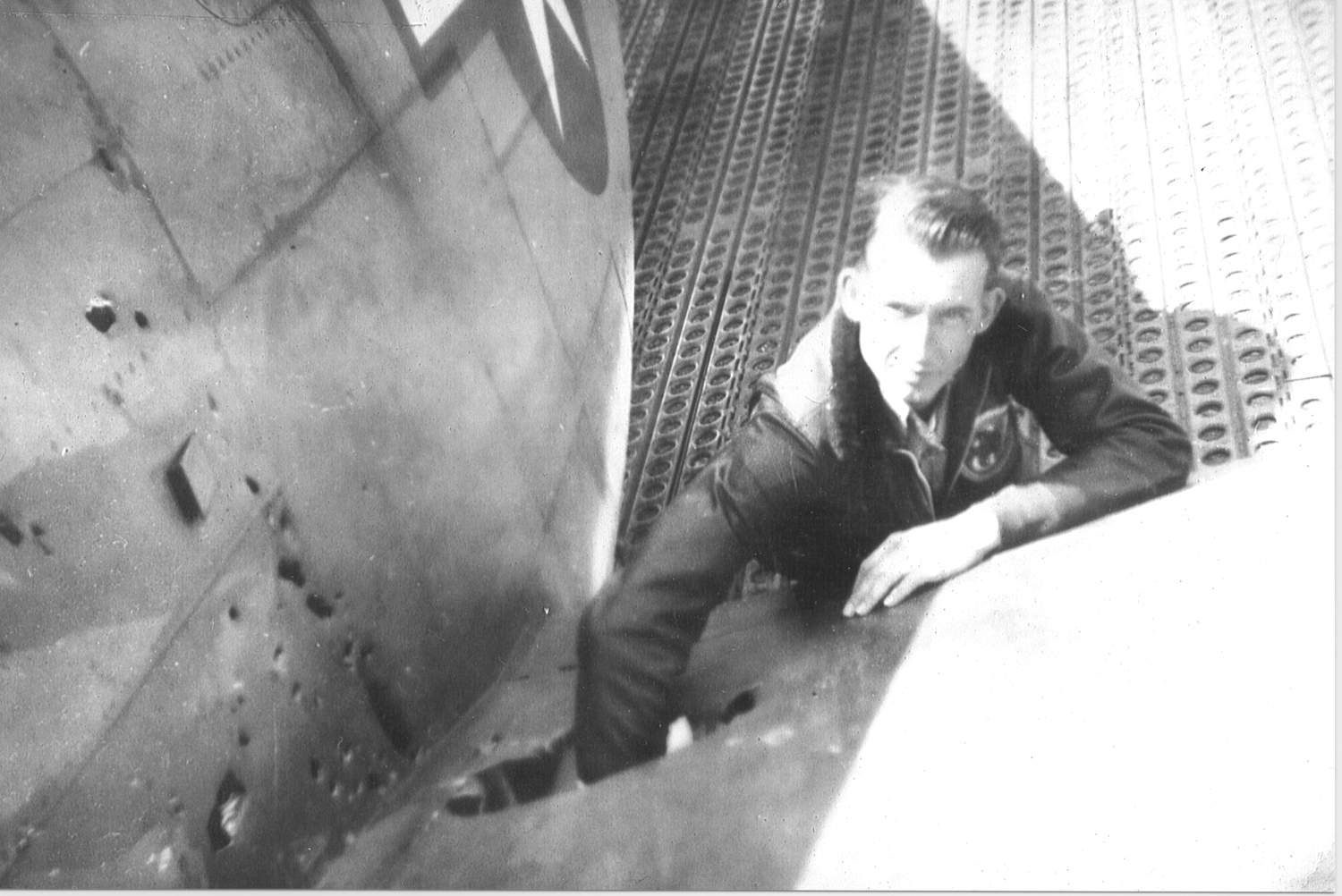 Lewis Barnes puts his arm into the left wing of Lieutenant Glen A. David’s plane