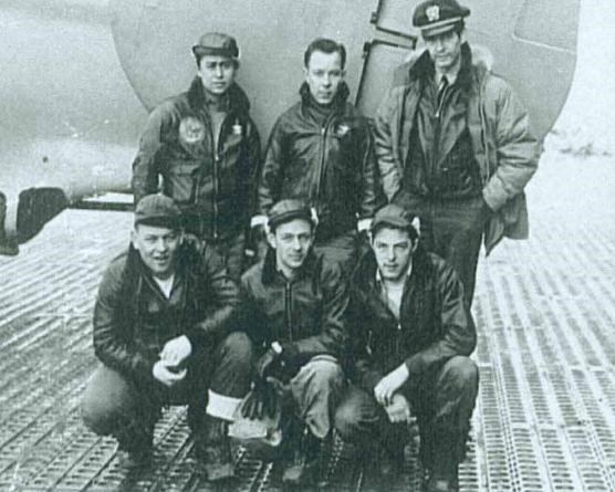 Crew posing by plane