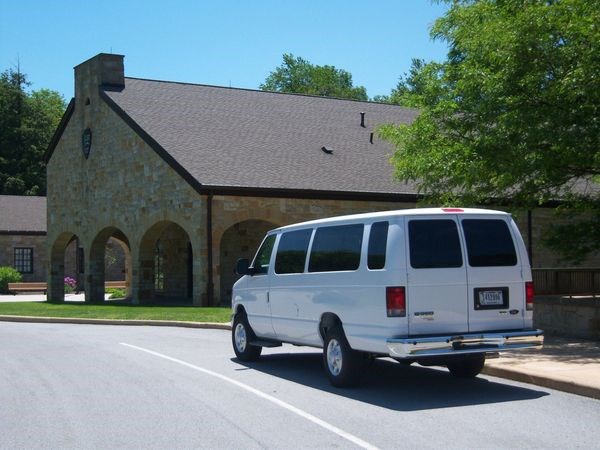 A white van parked by a building.