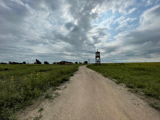 Image of Restored Barrack, Water Tower, and Guard Tower at Amache in 2023