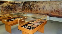 Replica of Native American artifacts in exhibit cases and scaled wall photograph of rock art. Credit: NPS/B Sontag