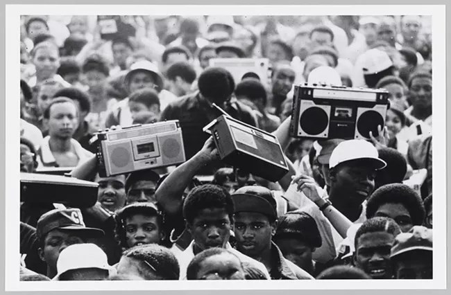 Many people are pictures, some holding up music radios