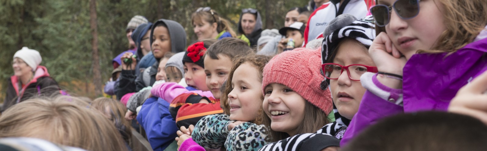 Students excitedly watching an unknown subject.