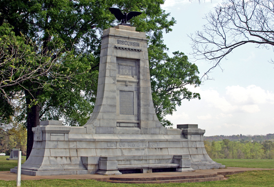 A large stone munument with an eagle statue located at the top.