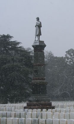 Falling snow coats a Civil War monument.