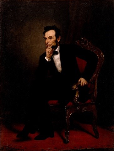 Lincoln sitting with his hand at his chin