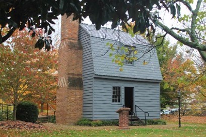 Johnson's Birthplace replica with fall colored trees