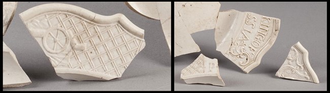 Close-up of wedge-shaped ceramic pieces. One has a cannon carriage etched on it.